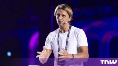 Nik Storonsky, CEO of Revolut, speaks on stage and gestures with his hands.