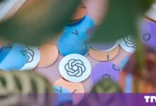 Colorful circular OpenAI stickers scattered on a pink surface