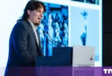 Palmer Luckey speaking at a podium during a conference in Taipei