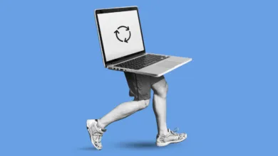 Laptop with running legs against a solid blue background