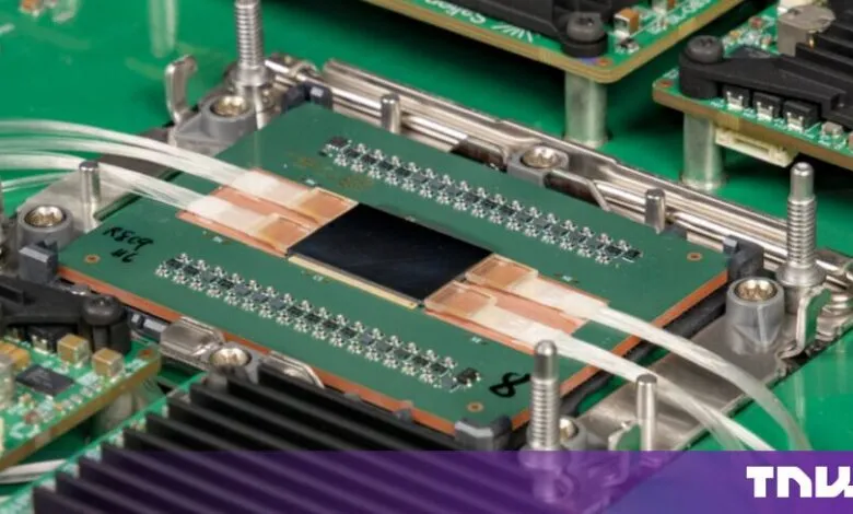 Close-up of an advanced photonic switch chip integrated with fiber optic cables on a green circuit board.