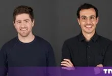 Portrait of Ramp co-founders Eric Glyman and Karim Atiyeh smiling against a dark grey background.