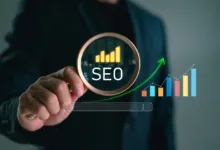 A person in a suit holds a magnifying glass over digital SEO text and rising growth charts.