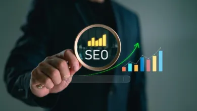 A person in a suit holds a magnifying glass over digital SEO text and rising growth charts.