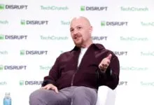 Replit CEO Amjad Masad speaking and gesturing during a panel at TechCrunch Disrupt.