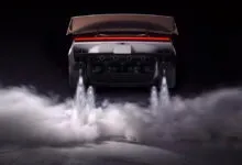 Rear view of futuristic sports car hovering with thrusters producing plumes of white smoke below