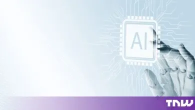 Robotic hand touching a glowing microchip graphic labeled AI against a light blue background.