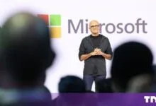 Microsoft CEO Satya Nadella smiling onstage during a presentation.