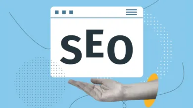 A human hand holds a browser window graphic displaying large bold SEO text on a light blue background.
