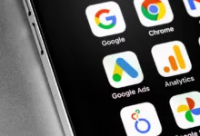 Close-up of smartphone screen displaying various Google app icons including Google Ads