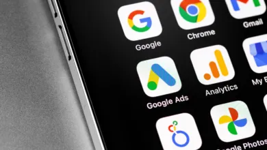 Close-up of smartphone screen displaying various Google app icons including Google Ads