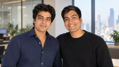 Amritanshu and Devansh, founders of Simplismart, smiling together in an office setting.