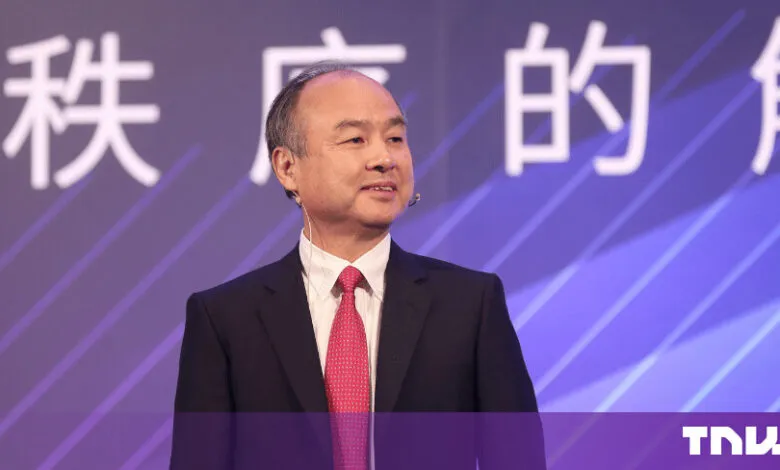SoftBank CEO Masayoshi Son speaking on a stage with a purple background.