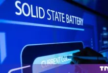 A hand uses a stylus to point at a digital diagram of a solid state battery on a blue screen.
