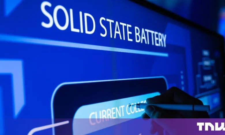A hand uses a stylus to point at a digital diagram of a solid state battery on a blue screen.