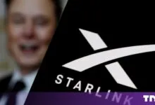 Elon Musk smiling next to the Starlink logo with TNW watermark