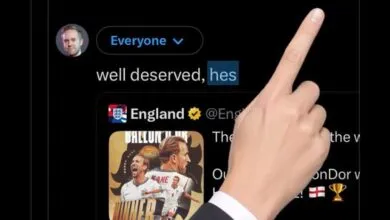 A human hand points at a tweet featuring English footballer Harry Kane and a post from the England national team.